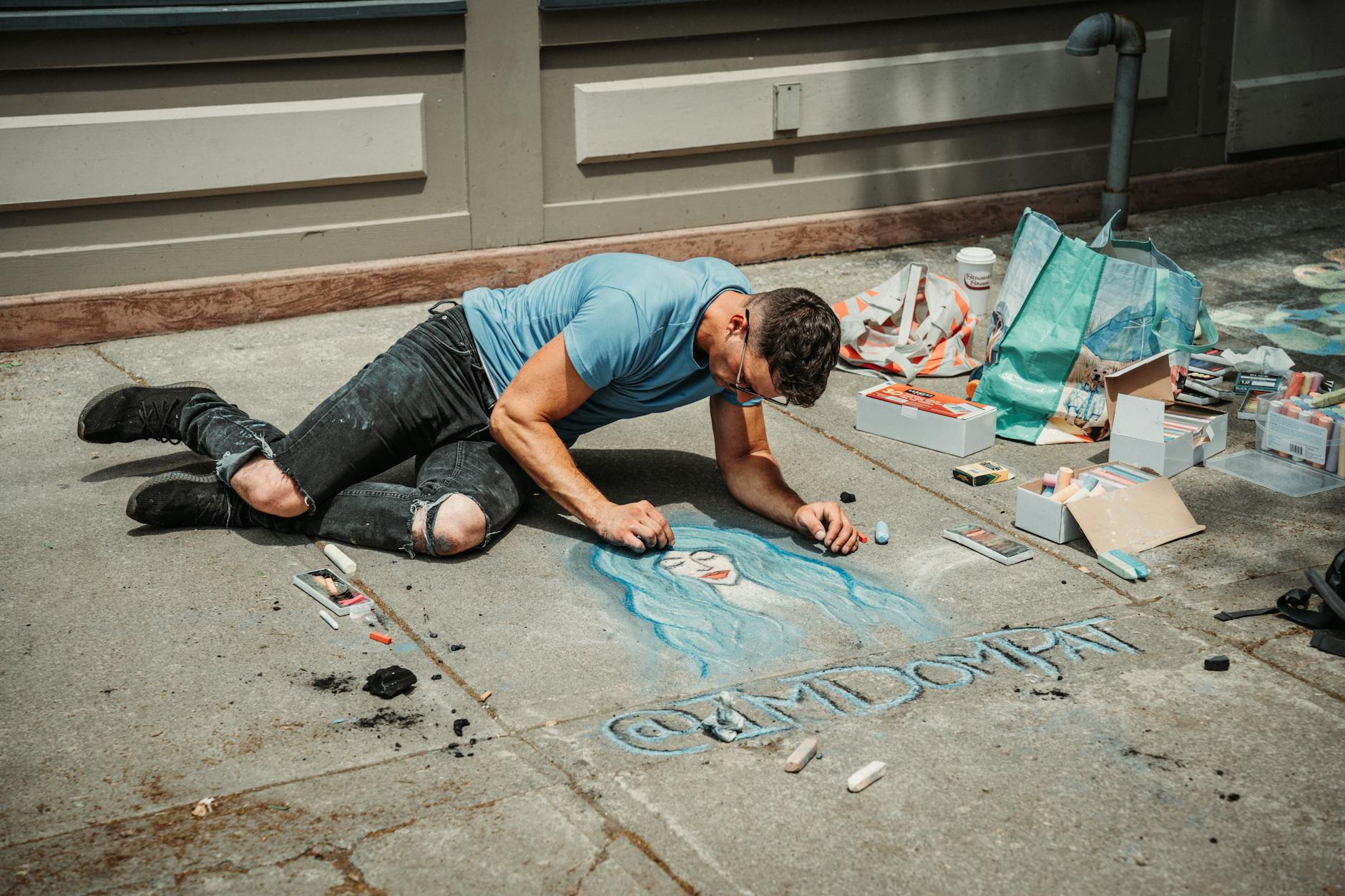 1. Chalk Paint a Dresser — The Classic Starter Flip - A street artist crafting a vibrant chalk artwork on an urban sidewalk.