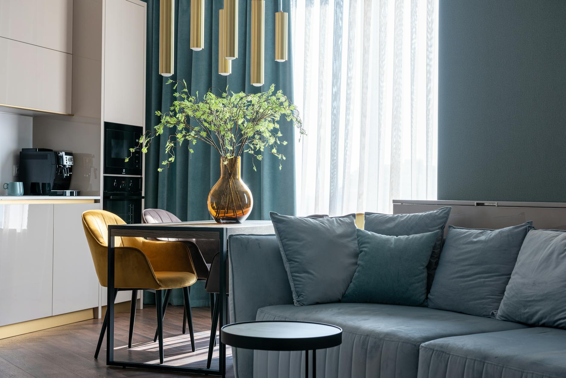Soft Furnishings: The Quickest Luxury Upgrade — $18 - Comfortable couch with pillows and wooden table with soft chairs in modern studi