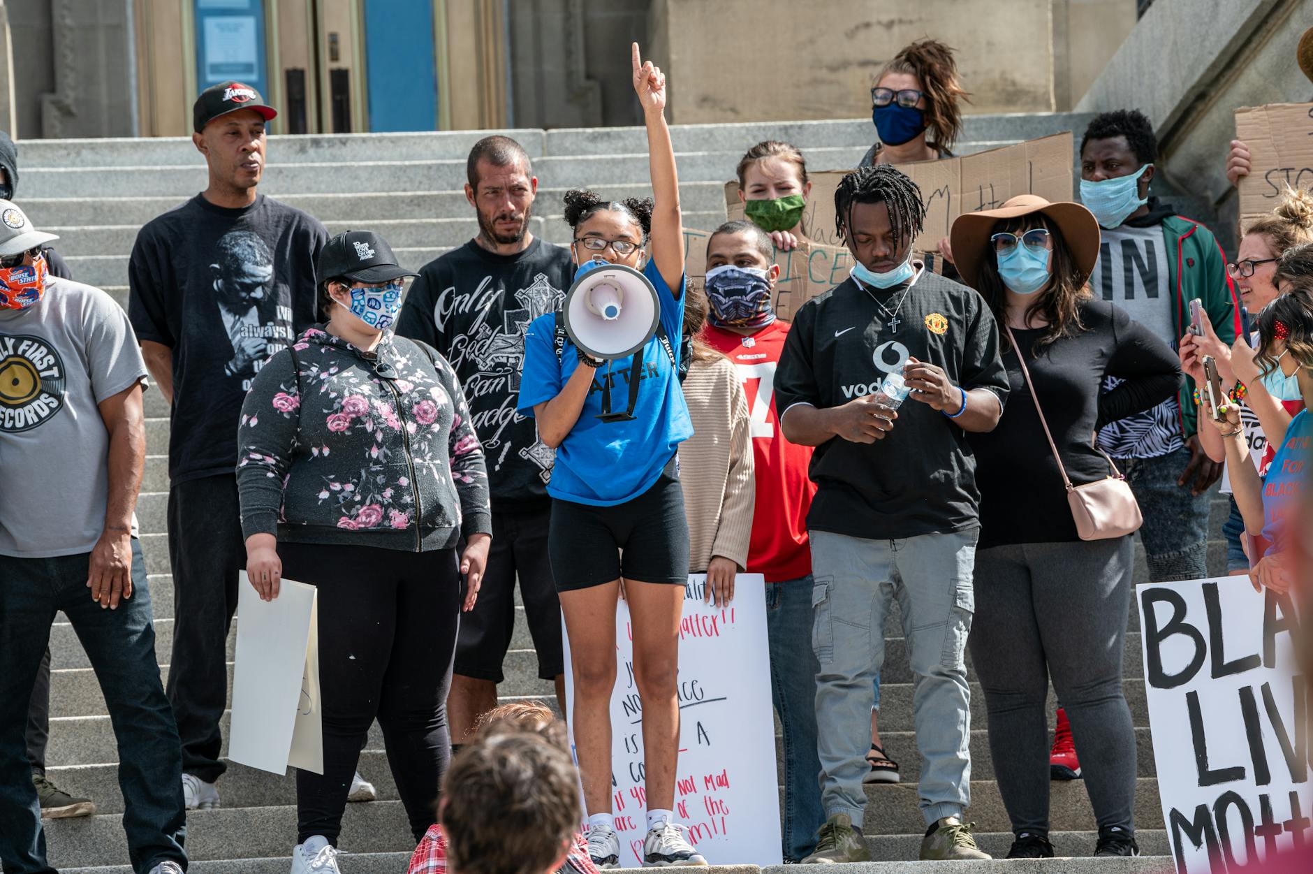 The Highest-Impact Change: New Lighting — $34.99 - A diverse group of people protesting outdoors for equality and justice.