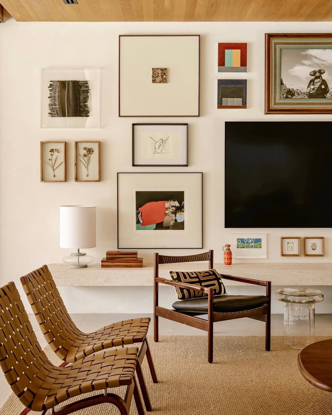 Budget DIY gallery wall above couch using affordable frames from thrift stores and dollar stores